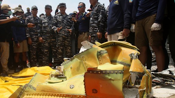 Navy personnel gather around debris recovered from the sea where the Lion Air jet that crashed in the waters of Tanjung Karawang, Indonesia, in November 2018.