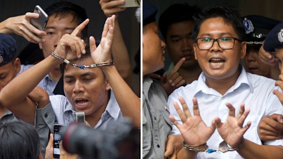 Reuters journalists Kyaw Soe Oo, left, and Wa Lone are escorted by police out of court on September 3.