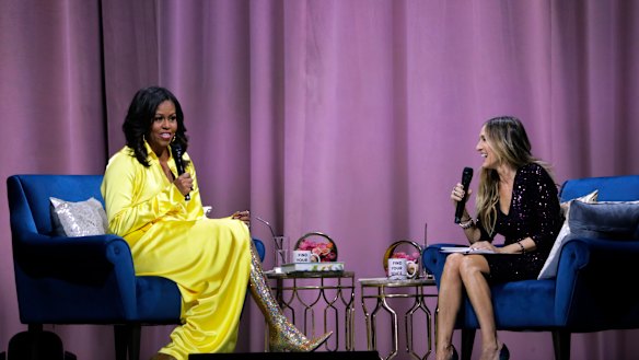 Former first lady Michelle Obama (left) is interviewed by Sarah Jessica Parker during an appearance for her book, "Becoming: An Intimate Conversation with Michelle Obama".