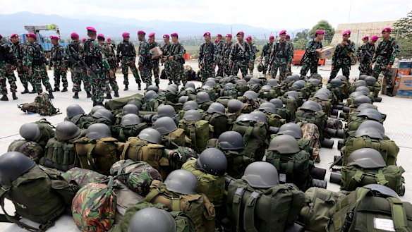 Indonesian Marines arrive to help deliver relief aid at the Mutiara Sis Al-Jufri airport in Palu on Thursday.