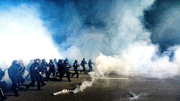 Police use chemical irritants and crowd control munitions to disperse protesters during a demonstration in Portland, Oregon. 