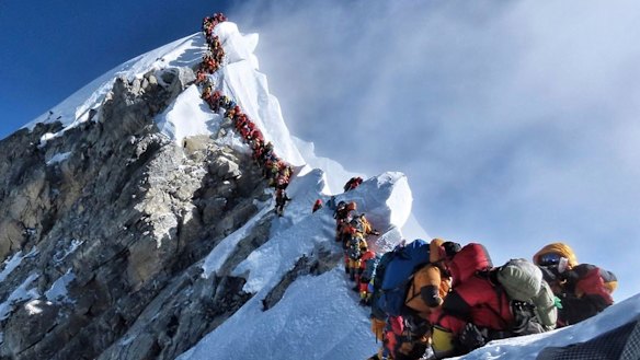 Climbers line up in the attempt to reach the peak of Mount Everest. 