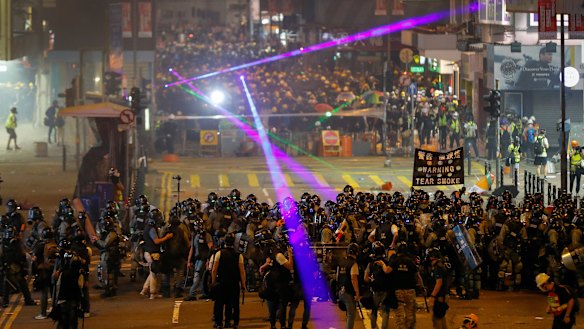 Protesters flash laser beams at police during an anti-extradition protest in Hong Kong on Sunday.
