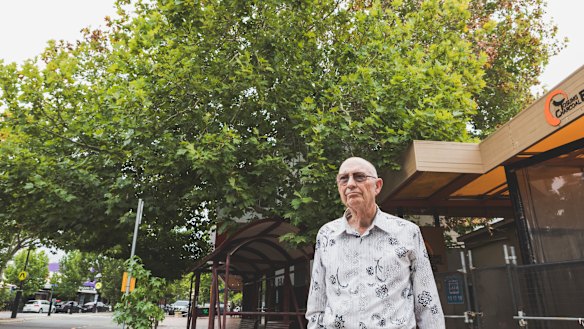 David Denham stands on Franklin Street, Manuka, in front of the protected London plane tree which appears to dying.