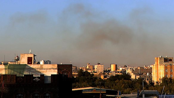 Smoke rises from the area around the international airport in Sanaa after the strikes.