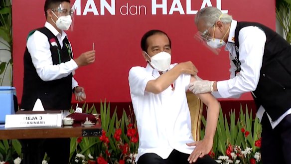 Indonesian President Joko Widodo, receives a shot against COVID-19 at the Merdeka Palace in Jakarta on Wednesday.