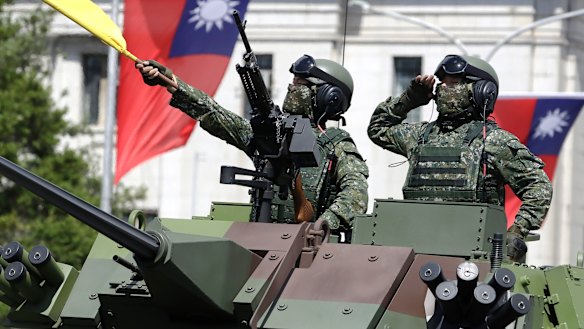 Taiwanese soldiers salute during National Day celebrations in front of the Presidential Office Building in Taipei in October. 