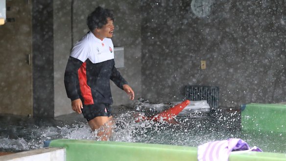 Rain or shine: The Cherry Blossoms train in a downpour at Chichibunomiya Rugby Stadium in Minato Ward, Tokyo, on Saturday.