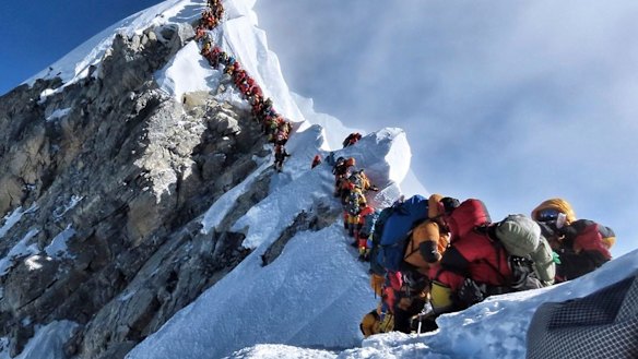 A photo of climbers lining up at the summit of Mount Everest sparked a debate over deaths and traffic jams.