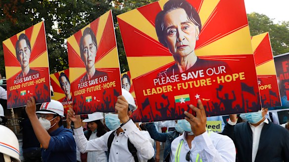 Engineers hold posters with an image of deposed Myanmar leader Aung San Suu Kyi as they hold an anti-coup protest march in Mandalay on Monday.