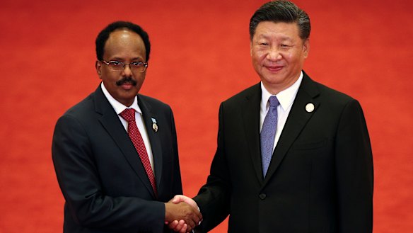 Somalia's President Mohamed Abdullahi Mohamed shakes hands with Xi Jinping.