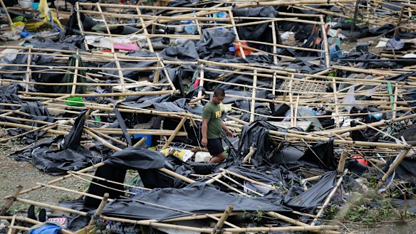 A policeman walks through makeshift tent shelters damaged by strong winds from Typhoon Mangkhut after it barreled across Tuguegarao city in Cagayan province, north-eastern Philippines on Sunday.
