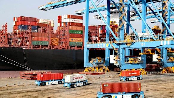 Rising giant: Automated vehicles move shipping containers at a port in China’s Shandong province.