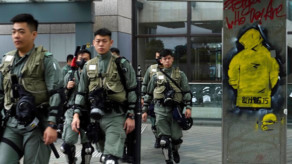 Riot policemen patrol near the government headquarters in Hong Kong on Tuesday.