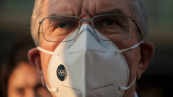 IOC President Thomas Bach wears a mask in Tokyo late last year.