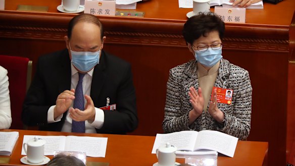 Hong Kong Chief Executive Carrie Lam, right, attends the opening session of China's National People's Congress (NPC) at the Great Hall of the People in Beijing. 
