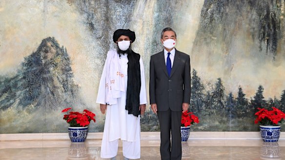 In July, Taliban co-founder Mullah Abdul Ghani Baradar, left, and Chinese Foreign Minister Wang Yi pose for a photo during their meeting in Tianjin, China. 