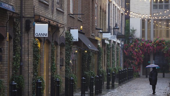 Lockdown: a pedestrian passes closed shops in Covent Garden.