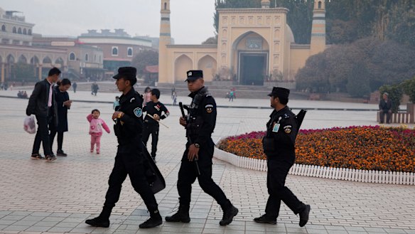Uighur security personnel patrol near the Id Kah Mosque in Kashgar in western China's Xinjiang region.