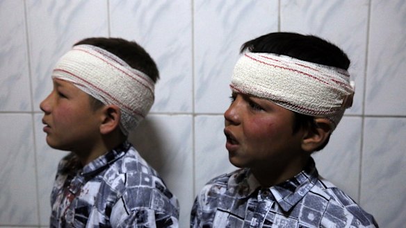 Two brothers wounded by an explosion are wrapped in gauze at a hospital in Kabul, Afghanistan, in March.