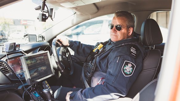 The head of ACT's road safety operations team, Sergeant Marcus Boorman, with the new traffic car technology.