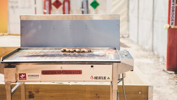 Minister for Climate Change and Sustainability Shane Rattenbury cooked sausages on a hydrogen-powered barbecue at the Canberra Institute of Technology Fyshwick campus.