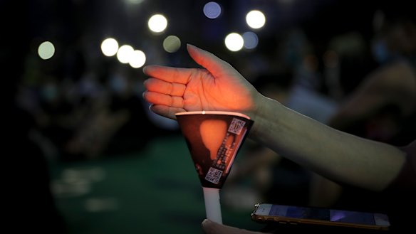 Activists defied bans to hold a candlelight vigil in Hong Kong.