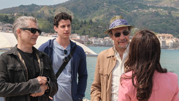 Valentina (Sabrina Impacciatore) greets Dominic Di Grasso (Michael Imperioli), his son Albie (Adam DiMarco) and father Bert (F. Murray Abraham) in The White Lotus.