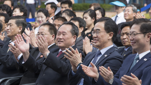 South Korea's Unification Minister Cho Myoung-gyon, second from right, and chairman of the North's Committee for the Peaceful Reunification Ri Son-gwon, third from left, applaud during an opening ceremony for the two Koreas' first liaison office in Kaesong, North Korea, in 2018.