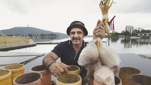 Pyrotechnician Fortunato Foti, pictured, packs mortars on Lake Burley Griffin on Thursday ahead of Saturday night's Skyfire.