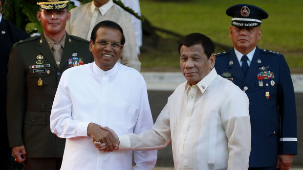 Like-minded: Sri Lanka President Maithripala Sirisena, left, and Philippine President Rodrigo Duterte shake hands in Manila last month.