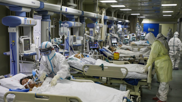 Medical workers treat patients in the isolated intensive care unit at a hospital in Wuhan in central China's Hubei province. 