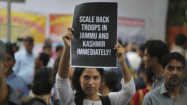 An Indian activist holds a placard during a protest against Indian government revoking Kashmir's special constitutional status in New Delhi on Wednesday.