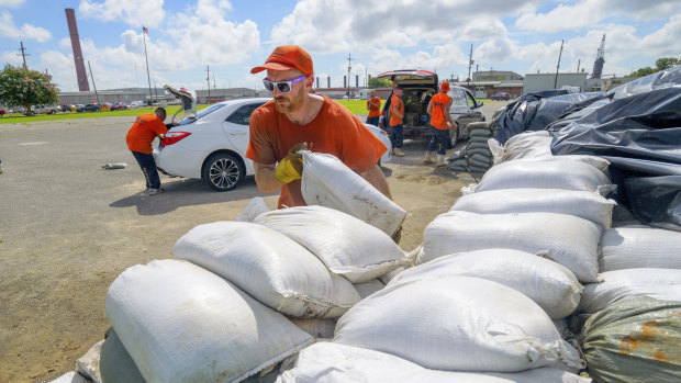 Workers move sandbags for residents in Chalmette, Louisiana, ahead of a possible hurricane.