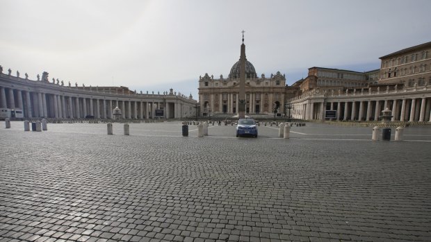 A police car is parked inside an empty St Peter's Square as Italy entered a nationwide lockdown on Thursday.