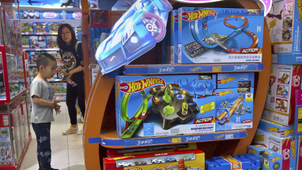 A boy looks at a display for Hot Wheels cars made by American toymaker Mattel at a toy store in Beijing. For many Chinese and Americans Donald Trump's trade war may soon get very real.