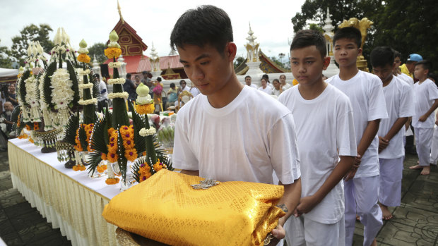 Soccer coach Ekaphol 'Ake' Chantawong, front, and members of the soccer team rescued from a flooded cave attend a Buddhist ceremony as they prepare to be ordained as Buddhist monks and novices in Mae Sai on Tuesday.
