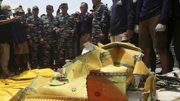Navy personnel gather around debris recovered from the sea where the Lion Air jet that crashed in the waters of Tanjung Karawang, Indonesia, in November 2018.