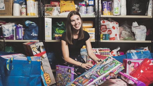 Fundraising and events officer at Anglicare ACT, Tatum Zotti,  is sorting through donations for their Christmas gift drive this year.