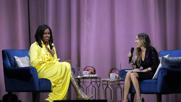 Former first lady Michelle Obama (left) is interviewed by Sarah Jessica Parker during an appearance for her book, "Becoming: An Intimate Conversation with Michelle Obama".