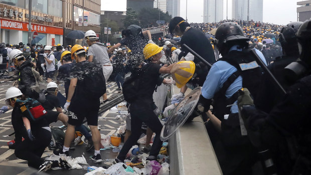 Police use pepper spray on demonstrators near the Legislative Council.