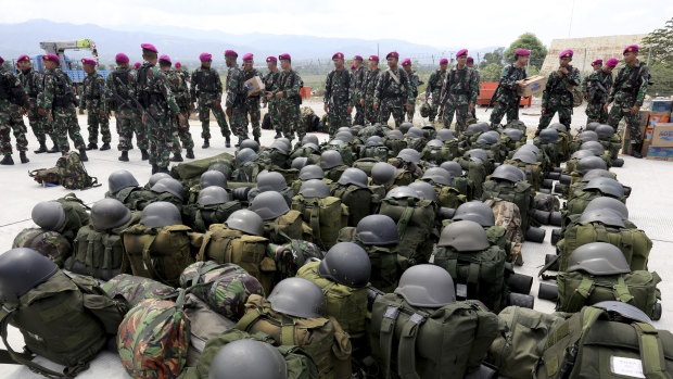 Indonesian Marines arrive to help deliver relief aid at the Mutiara Sis Al-Jufri airport in Palu on Thursday.