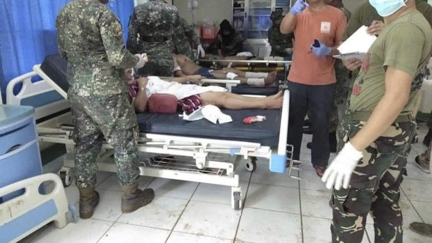 In this photo provided by WESMINCOM Armed Forces of the Philippines, bomb victims receive treatment in a hospital after two bombs exploded outside a Roman Catholic cathedral in Jolo.
