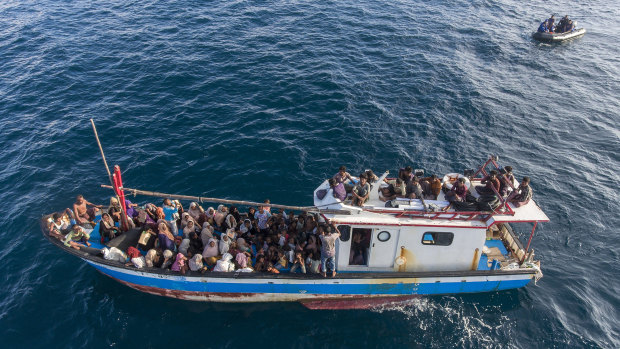A boat carries ethnic Rohingya off North Aceh, Indonesia, on June 24.