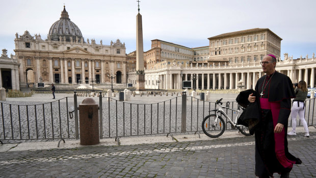 A prelate walks outside St Peter's Square after the Vatican erected a new barricade at the edge of the square, in Rome.