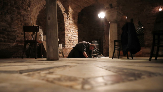 A man works in the St Mark's Basilica crypt in Venice, Italy, last week.