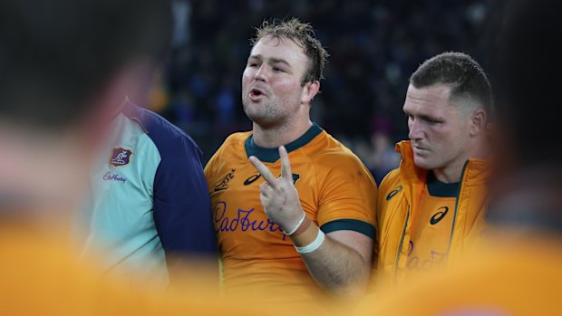 Captain Harry Wilson speaks to his team after the defeat in Italy.