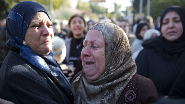 Women cry during the funeral for Maasarwe.