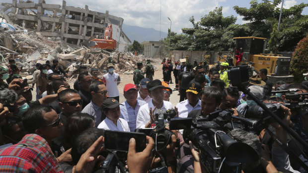 Indonesian President Joko Widodo, centre, after visiting  earthquake and tsunami-damaged Roa-Roa Hotel in Palu.