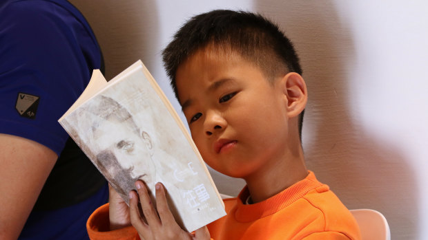 A boy reading “Once”, a book by  Morris Gleitzman at Beijing Happy Space.